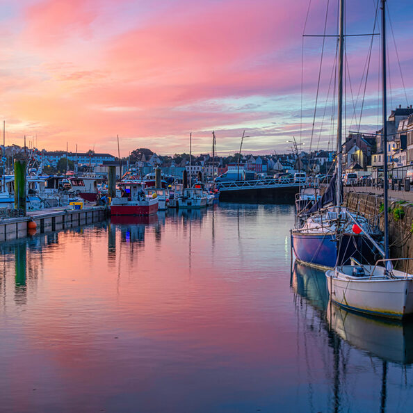 Breathtaking colorful sunrise over the harbor of Audierne, Brittany, France